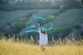 A teenage girl with a gymnastic ribbon on a hillside Royalty Free Stock Photo