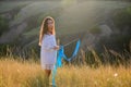 A teenage girl with a gymnastic ribbon on a hillside Royalty Free Stock Photo