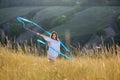 A teenage girl with a gymnastic ribbon on a hillside Royalty Free Stock Photo