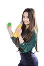 Teenage girl happy while holding a bottle of orange juice.in a green blouse. isolated on a white background Royalty Free Stock Photo