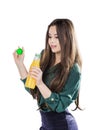 Teenage girl happy while holding a bottle of orange juice.in a green blouse. isolated on a white background Royalty Free Stock Photo