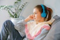 Teenager girl in headphones listens to calm music, music brings pleasure and relaxation, lifestyle