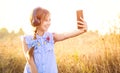 Teenage girl with headphones taking cute selfie