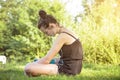 Teenage girl hears music in a garden