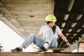 Teenage girl in helmet and stylish clothes posing on half pipe ramp an outdoor skate park. Beautiful kid female model skateboarder Royalty Free Stock Photo