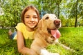 Teenage girl with her dog laying in park Royalty Free Stock Photo