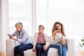 A teenage girl, mother and grandmother with smartphone at home. Royalty Free Stock Photo