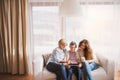 A teenage girl, mother and grandmother with tablet at home. Royalty Free Stock Photo