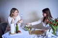 a teenage girl and her mother in pajamas are cooking and eating a fresh green and tomato salad together Royalty Free Stock Photo