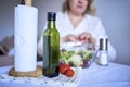 a teenage girl and her mother in pajamas are cooking and eating a fresh green and tomato salad together Royalty Free Stock Photo