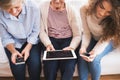 A teenage girl, mother and grandmother with tablet at home. Royalty Free Stock Photo