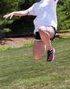 Teenage girl high in the air practicing long jump Royalty Free Stock Photo