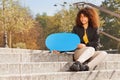 Teenage girl holding blue empty speech bubble Royalty Free Stock Photo