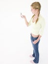 Teenage girl holding cellular phone and smiling