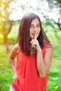 Teenage girl holding finger near lips Royalty Free Stock Photo