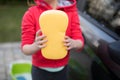 Teenage girl holding a sponge on a sunny day Royalty Free Stock Photo