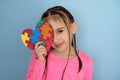 A teenage girl holds an autism symbol in her hand Royalty Free Stock Photo