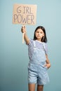 Teenage girl holds banner girl power. Young feministic woman protest against misogynistic society