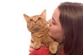 Teenage girl holds orange tabby cat