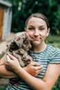 Teenage girl holds and snuggles with new labradoodle puppies