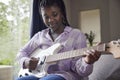 Teenage Girl At Home Learning To Play Electric Guitar Royalty Free Stock Photo