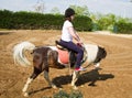 Teenage girl on horseback wearing helmet