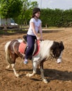 Teenage girl on horseback wearing helmet