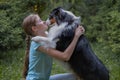 teenage girl hug australian shepherd dog in summer. in forest Royalty Free Stock Photo