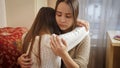Teenage girl hugging and consoling her crying friend at bedroom. Friends support and teenager depression Royalty Free Stock Photo