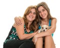 Teenage girl hugging her mother and their little dog Royalty Free Stock Photo