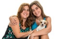 Teenage girl hugging her mother and their little dog