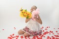 Teenage girl hugging a Valentine`s day gift and a bunch of flowers Royalty Free Stock Photo