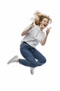 A teenage girl is jumping. Laughing girl in a white T-shirt and blue jeans. Activity and positive. Isolated on a white background