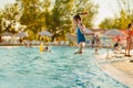 Teenage girl jumps into the water from the side of the pool Royalty Free Stock Photo