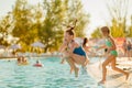 Teenage girl jumps into the water from the side of the pool Royalty Free Stock Photo