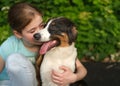 teenage girl kiss australian shepherd puppy dog in summer. Outdoor Royalty Free Stock Photo