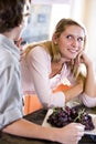 Teenage girl on kitchen counter with brother Royalty Free Stock Photo