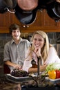 Teenage girl in kitchen with younger brother Royalty Free Stock Photo