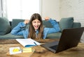 Teenage girl on laptop studying online at home as high school is closed due to new COVID-19 Lockdown Royalty Free Stock Photo