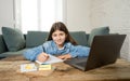 Teenage girl on laptop studying online at home as high school is closed due to new COVID-19 Lockdown Royalty Free Stock Photo