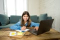 Teenage girl on laptop studying online at home as high school is closed due to new COVID-19 Lockdown Royalty Free Stock Photo