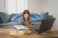 Teenage girl on laptop studying online at home as high school is closed due to new COVID-19 Lockdown Royalty Free Stock Photo