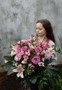 Teenage girl with large bunch of flowers Royalty Free Stock Photo