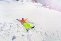 Teenage girl lay in star shape wear ski outfit