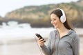 Teenage girl listening to music on the beach Royalty Free Stock Photo