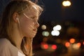 Teenage girl listening to music portrait on the street background. Teen girl with headphones