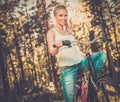 Teenage girl listens music on a bicycle outdoors Royalty Free Stock Photo