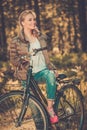 Teenage girl listens music on a bicycle outdoors Royalty Free Stock Photo