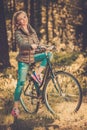 Teenage girl listens music on a bicycle outdoors Royalty Free Stock Photo