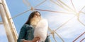 Teenage girl with long loose flowing hair eats cotton candy